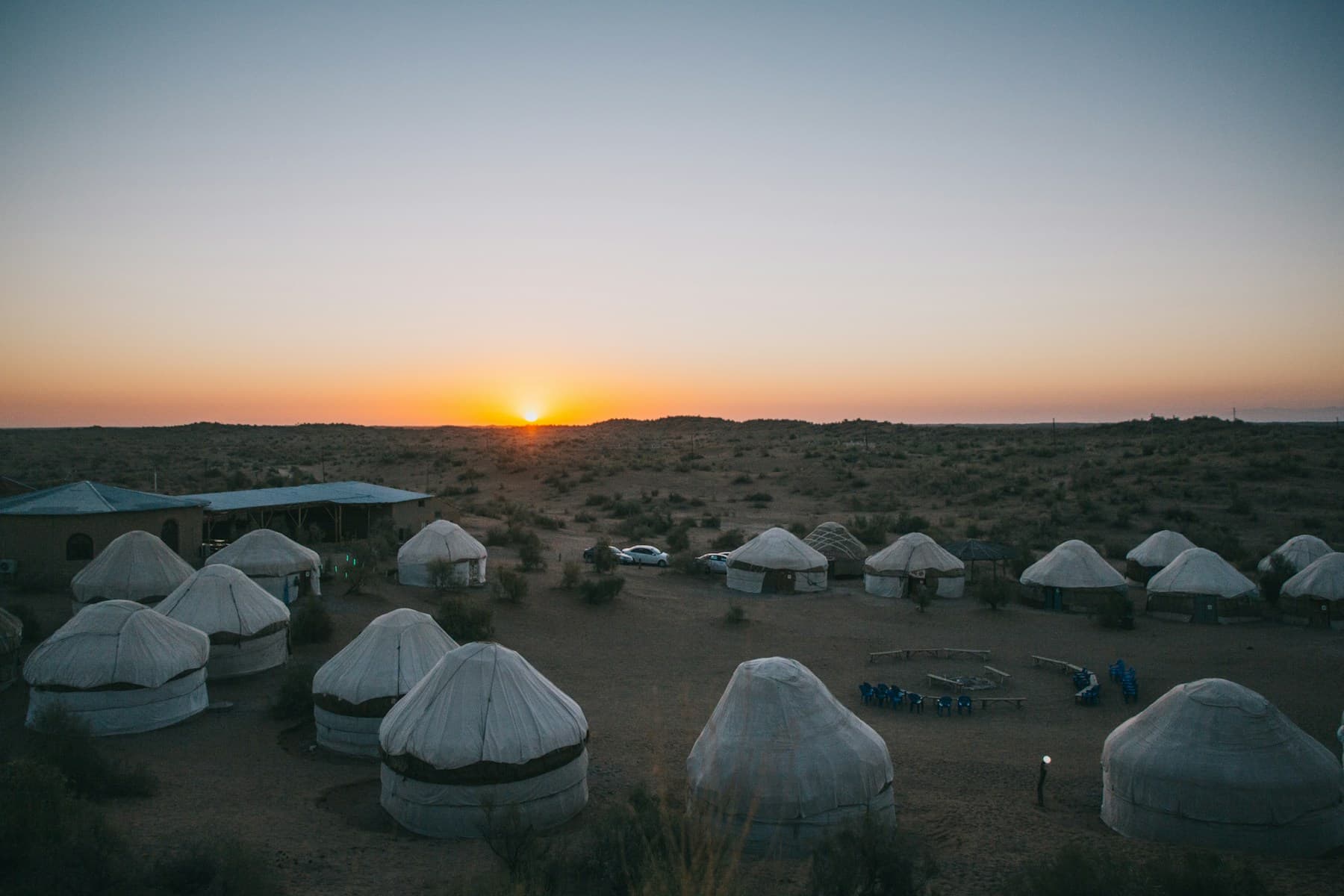 A tented camp in the desert at sunset